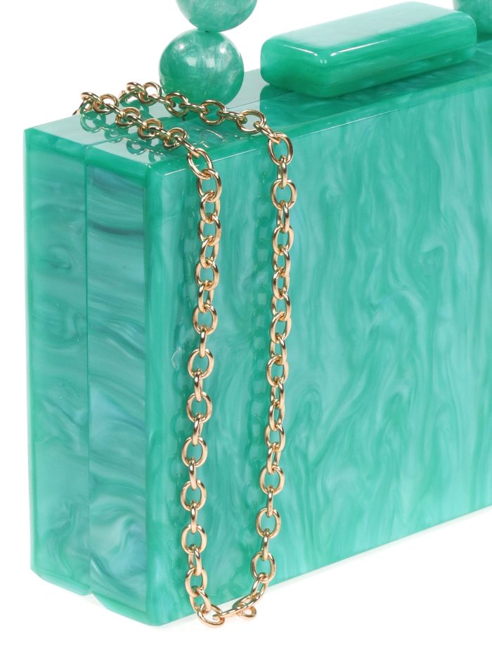 Clutch fiesta nácar detalle asa esmeralda