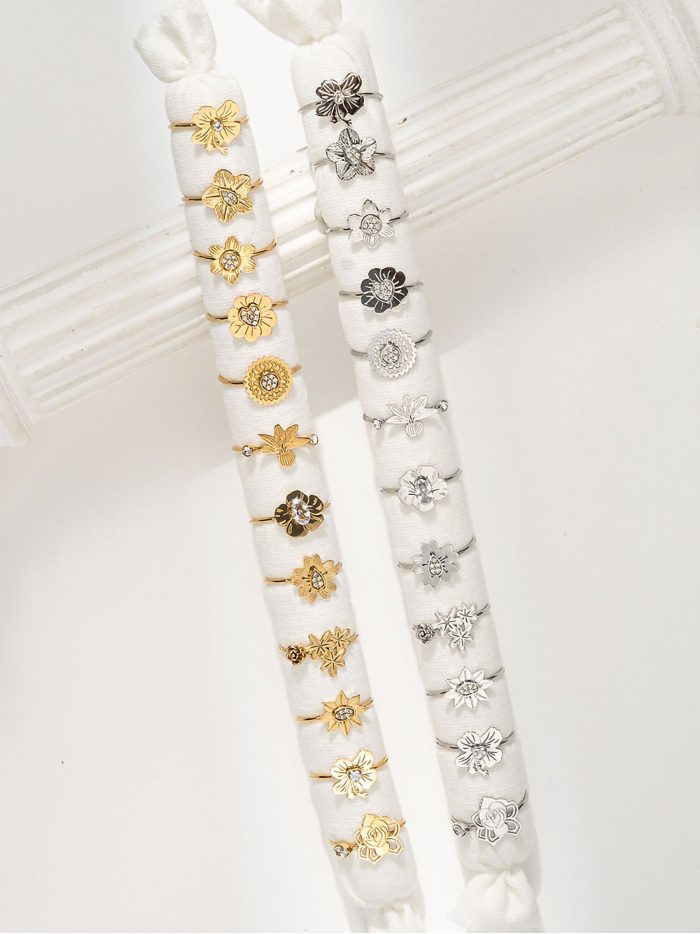 Conjunto de 12 anillos flores con circonitas - Acero inoxidable - Expositor incluido