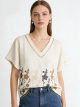 Blusa con scollo a V ricamata con fiori