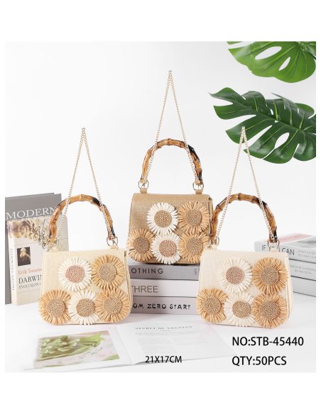 Mini bolsa de ráfia com flores e alça com efeito de bambu.