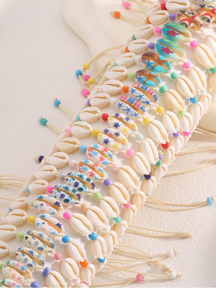 Lot de 24 bracelets réglables coquillages effet naturel avec présentoir