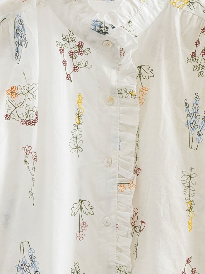 Chemisier brodé de fleurs avec volant sur le devant