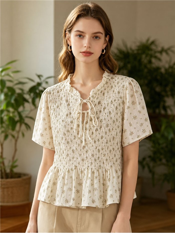 Blusa floreale arricciata con peplo