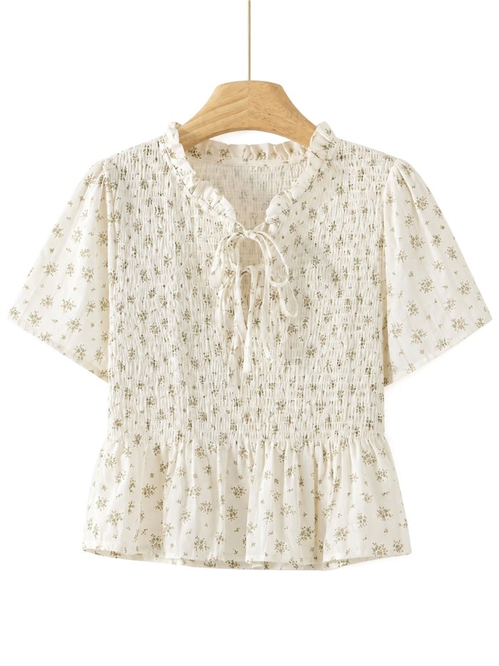 Blusa floreale arricciata con peplo