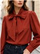 Blusa lisa con lazo al cuello
