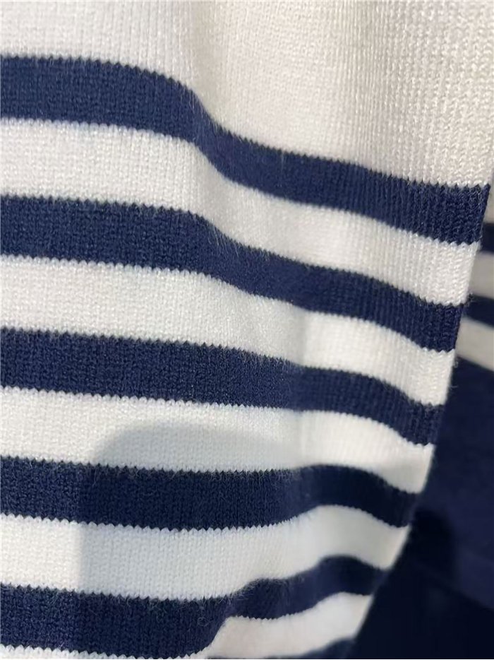 Completo composto da maglione e pantaloni oversize a righe.