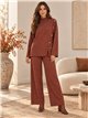 Completo composto da maglione e pantaloni con bottoni laterali